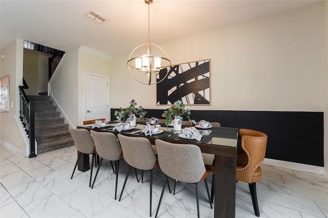 8896 Cabot Cliffs Dr, Davenport, FL 33896 - dining space featuring light marble finish flooring, a chandelier, stairs, and baseboards