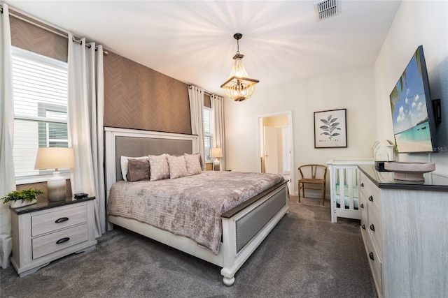 carpeted bedroom with a chandelier and multiple windows