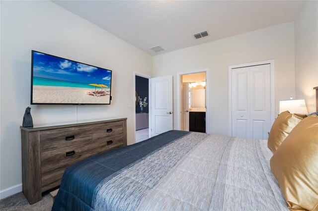 8896 Cabot Cliffs Dr, Davenport, FL 33896 - carpeted bedroom with baseboards, a closet, and ensuite bath
