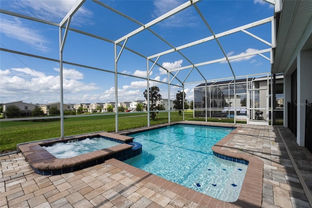 view of pool with a patio, an in ground hot tub, a lawn, and a lanai