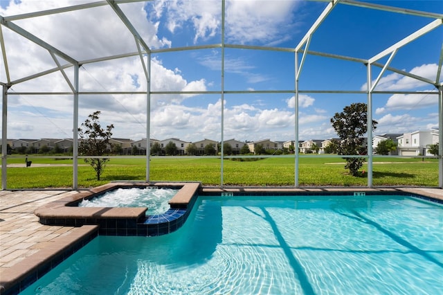 view of swimming pool featuring a lanai, a yard, and an in ground hot tub