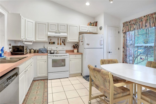 kitchen with white cabinets, vaulted ceiling, and white appliances