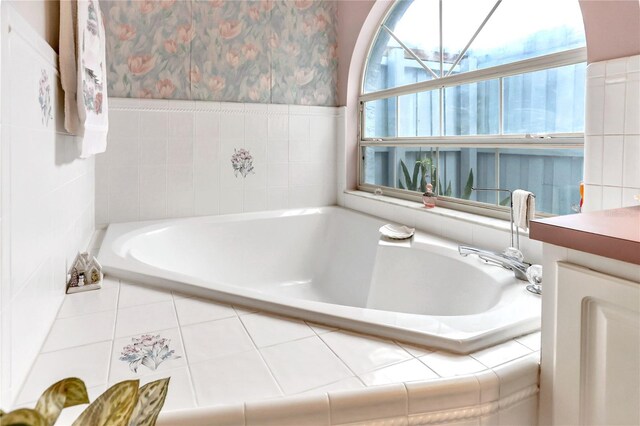 bathroom with vanity and tiled bath