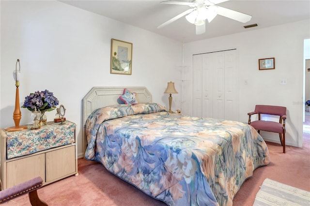 carpeted bedroom featuring a closet and ceiling fan