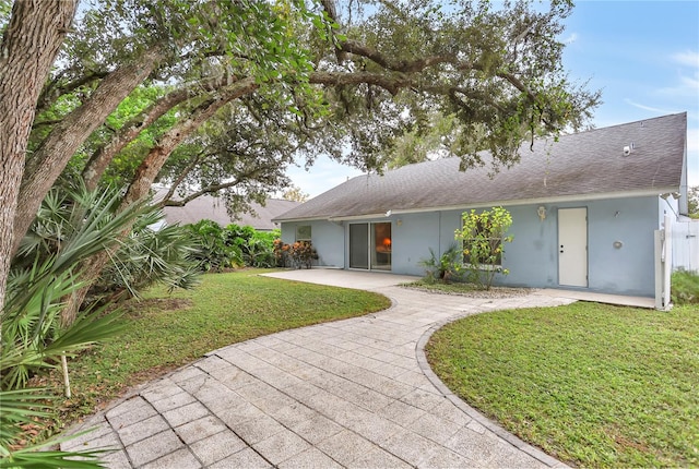 ranch-style home featuring a patio and a front yard