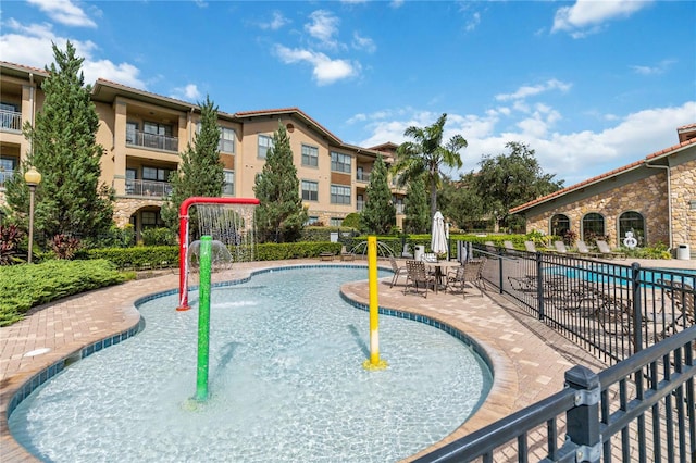 view of swimming pool with a patio and pool water feature