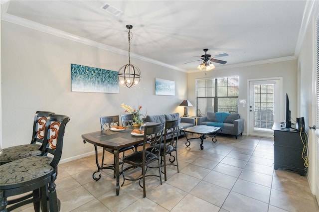 tiled dining area with ornamental molding and ceiling fan with notable chandelier