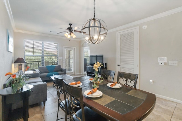 tiled dining room featuring crown molding and ceiling fan with notable chandelier