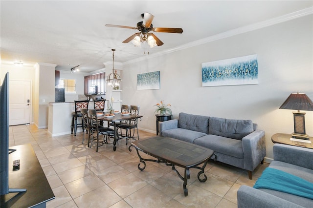 tiled living room featuring ornamental molding and ceiling fan with notable chandelier