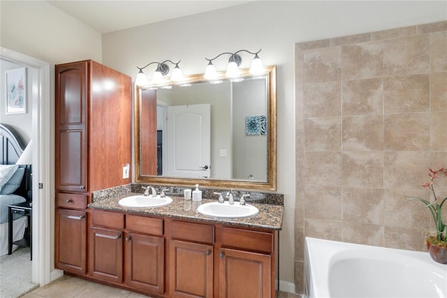 bathroom with vanity, tile patterned floors, and a bath