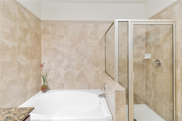 bathroom featuring vanity and plus walk in shower