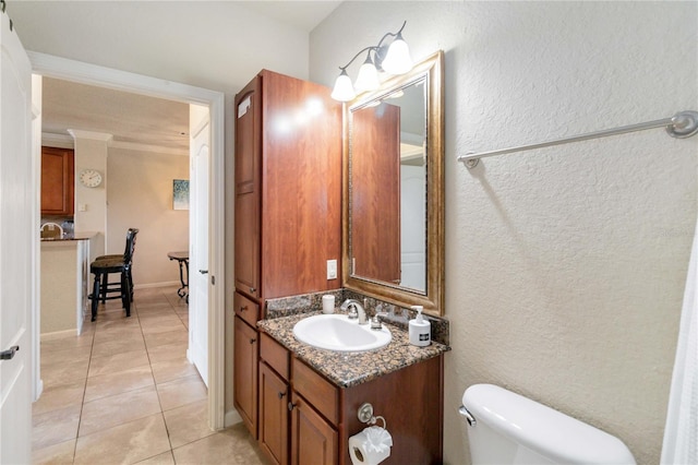 bathroom featuring toilet, vanity, and tile patterned flooring