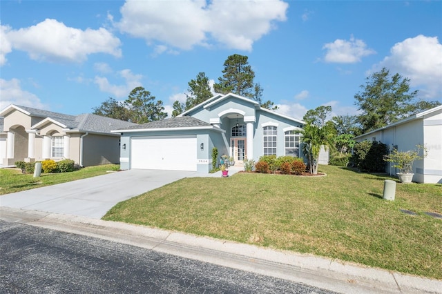 ranch-style house featuring a garage and a front lawn