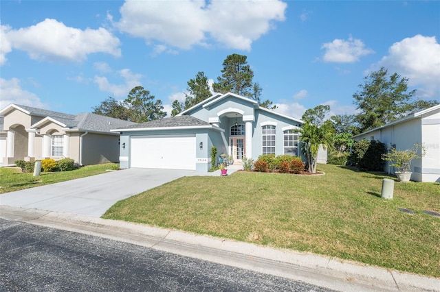 single story home featuring stucco siding, a front lawn, driveway, and an attached garage