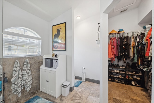 bathroom featuring vaulted ceiling