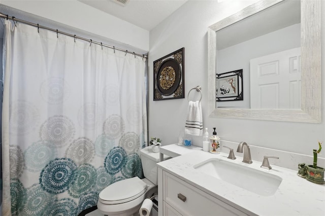 bathroom featuring toilet, a textured ceiling, a shower with curtain, and vanity