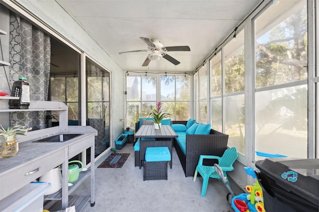 sunroom / solarium with a ceiling fan and outdoor lounge area