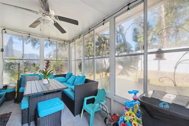 sunroom / solarium featuring ceiling fan