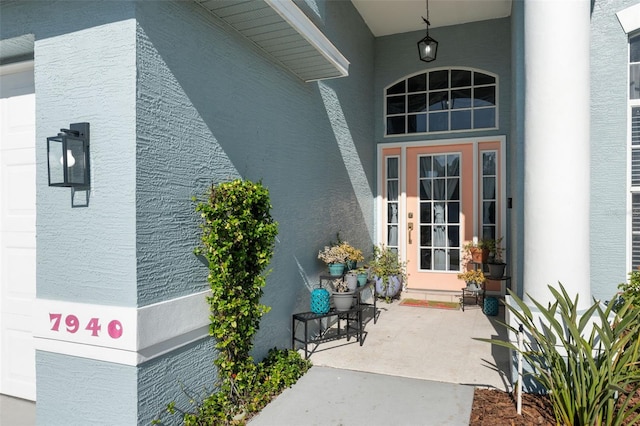 entrance to property featuring stucco siding