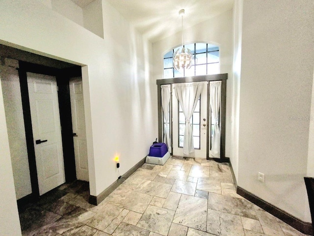 7940 Fashion Loop, New Port Richey, FL 34654 - entrance foyer featuring stone tile floors, a chandelier, and a high ceiling