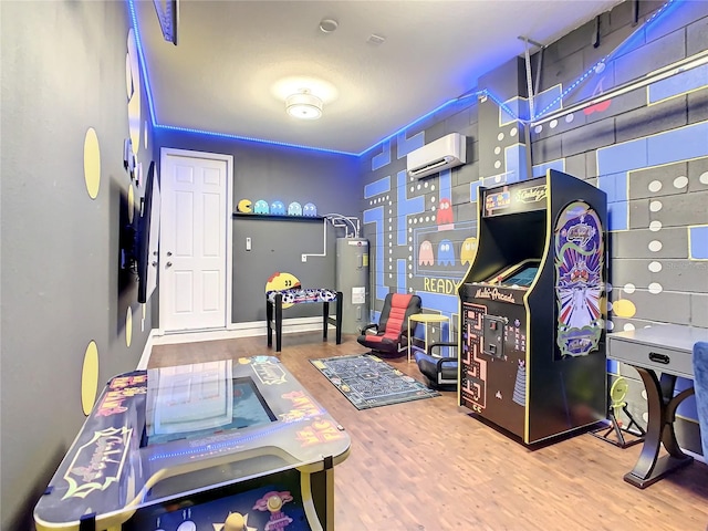 playroom with a wall mounted AC, wood-type flooring, and electric water heater