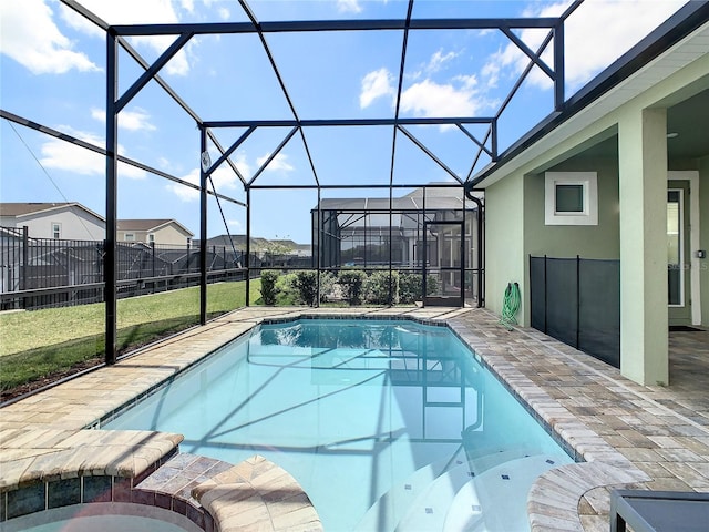 view of pool with a patio area, a yard, and glass enclosure