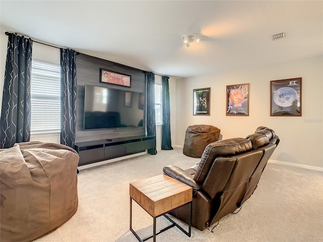 carpeted living room with a healthy amount of sunlight