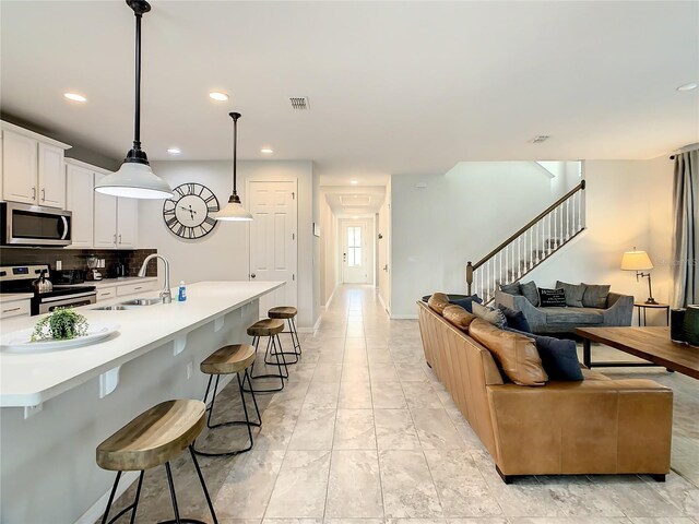 1861 Sawyer Palm Pl, Kissimmee, FL 34747 - living room with recessed lighting, stairs, and light marble finish flooring