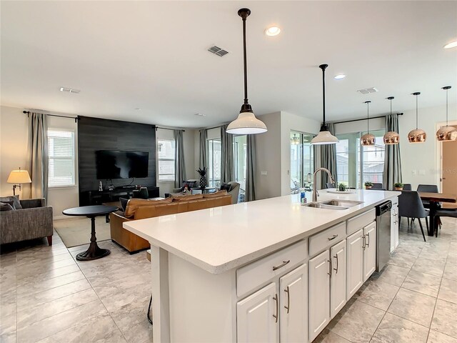 1861 Sawyer Palm Pl, Kissimmee, FL 34747 - kitchen with a sink, open floor plan, stainless steel dishwasher, light countertops, and white cabinetry