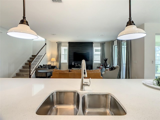 kitchen with sink, hanging light fixtures, and plenty of natural light