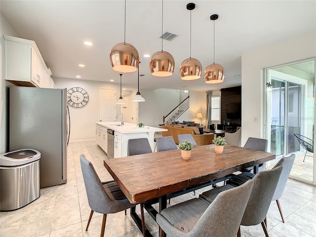 dining room with sink and light tile patterned floors