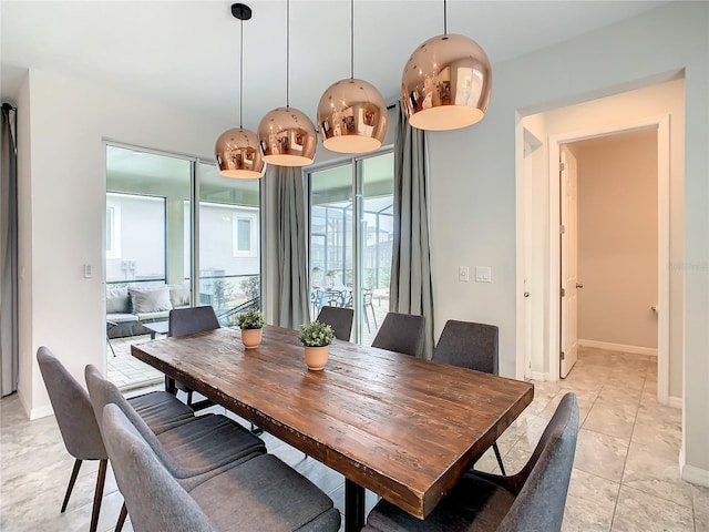 dining space with a wealth of natural light and light tile patterned floors