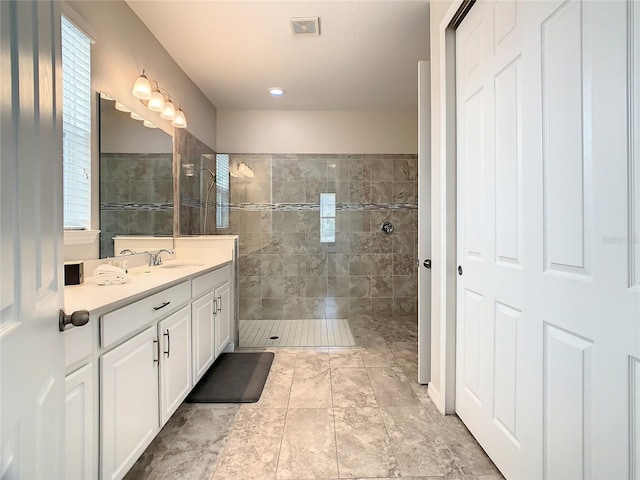 bathroom featuring vanity and tiled shower