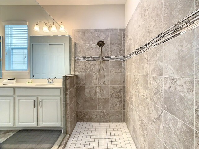 bathroom featuring vanity and tiled shower