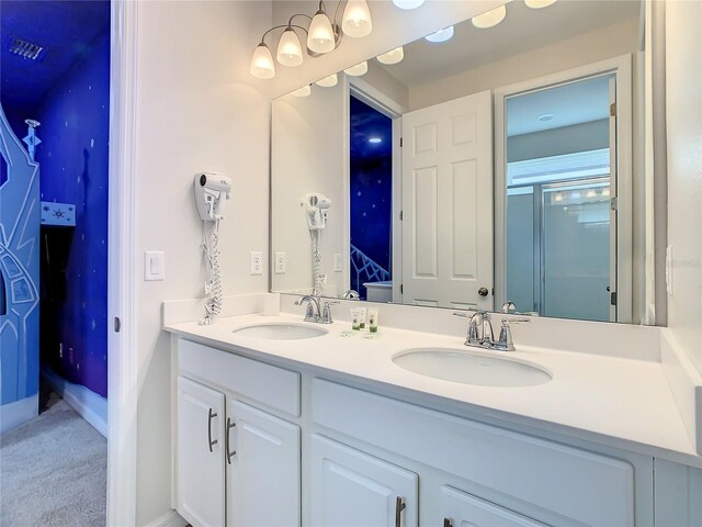 1861 Sawyer Palm Pl, Kissimmee, FL 34747 - bathroom with double vanity, baseboards, and a shower with shower door