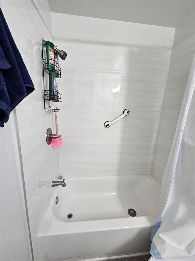 bathroom with shower / bath combo with shower curtain