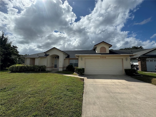 single story home featuring a front yard and a garage