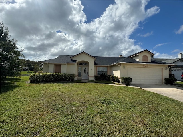 single story home featuring a front lawn and a garage