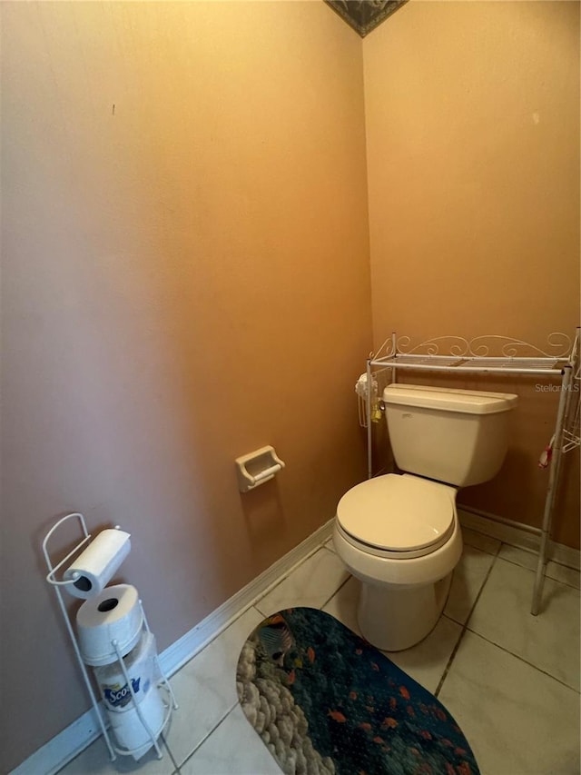 bathroom with toilet and tile patterned flooring