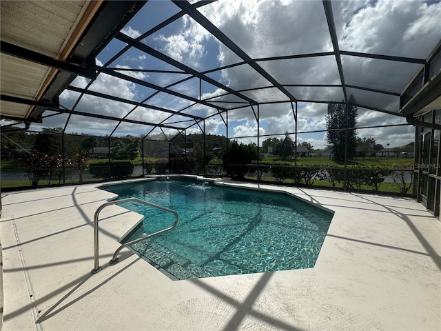 view of swimming pool featuring a patio and a lanai