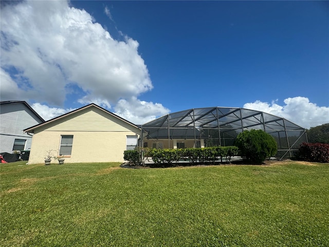 view of yard with glass enclosure