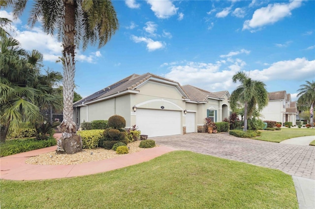 view of front facade with a front yard and a garage