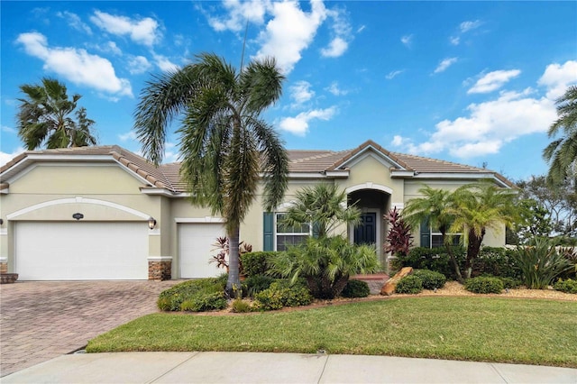 view of front of property featuring a garage and a front lawn