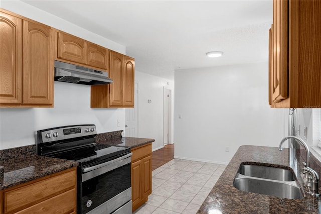 2319 Continental Blvd, Orlando, FL 32808 - kitchen with electric range, marble finish floor, under cabinet range hood, a sink, and dark stone countertops