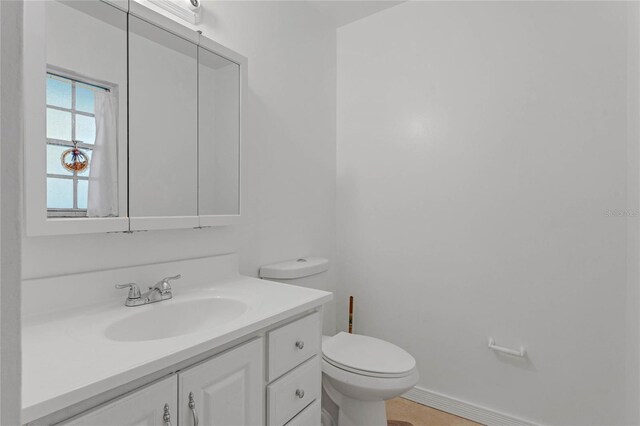 2319 Continental Blvd, Orlando, FL 32808 - half bathroom with vanity, baseboards, and toilet