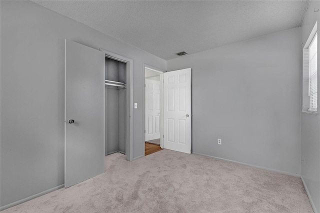 2319 Continental Blvd, Orlando, FL 32808 - unfurnished bedroom featuring visible vents, a closet, baseboards, a textured ceiling, and carpet