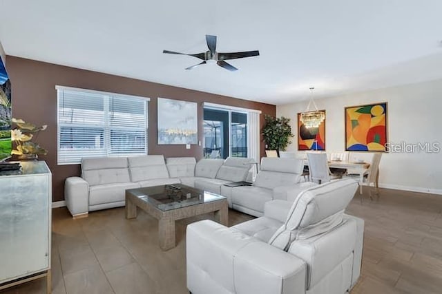 living room with light hardwood / wood-style flooring, ceiling fan, and a wealth of natural light