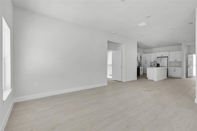 unfurnished living room with light wood-type flooring