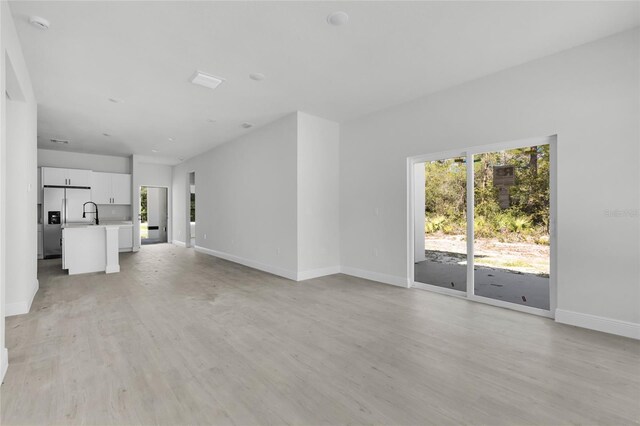 unfurnished living room with light wood-type flooring