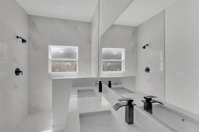 bathroom with vanity and tiled shower